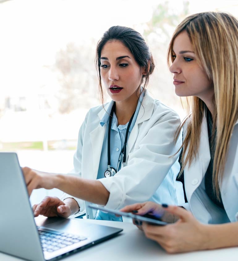 doctors looking at a laptop