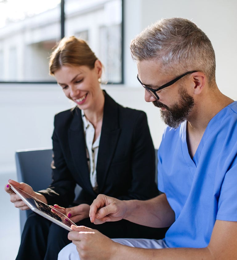 doctor and consultant looking at a tablet